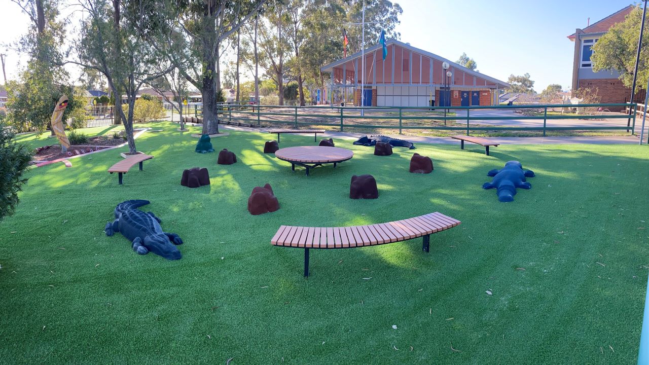 Yarning Circle installed at Busby Public School that includes curved benches, platform, rubber rocks & animals