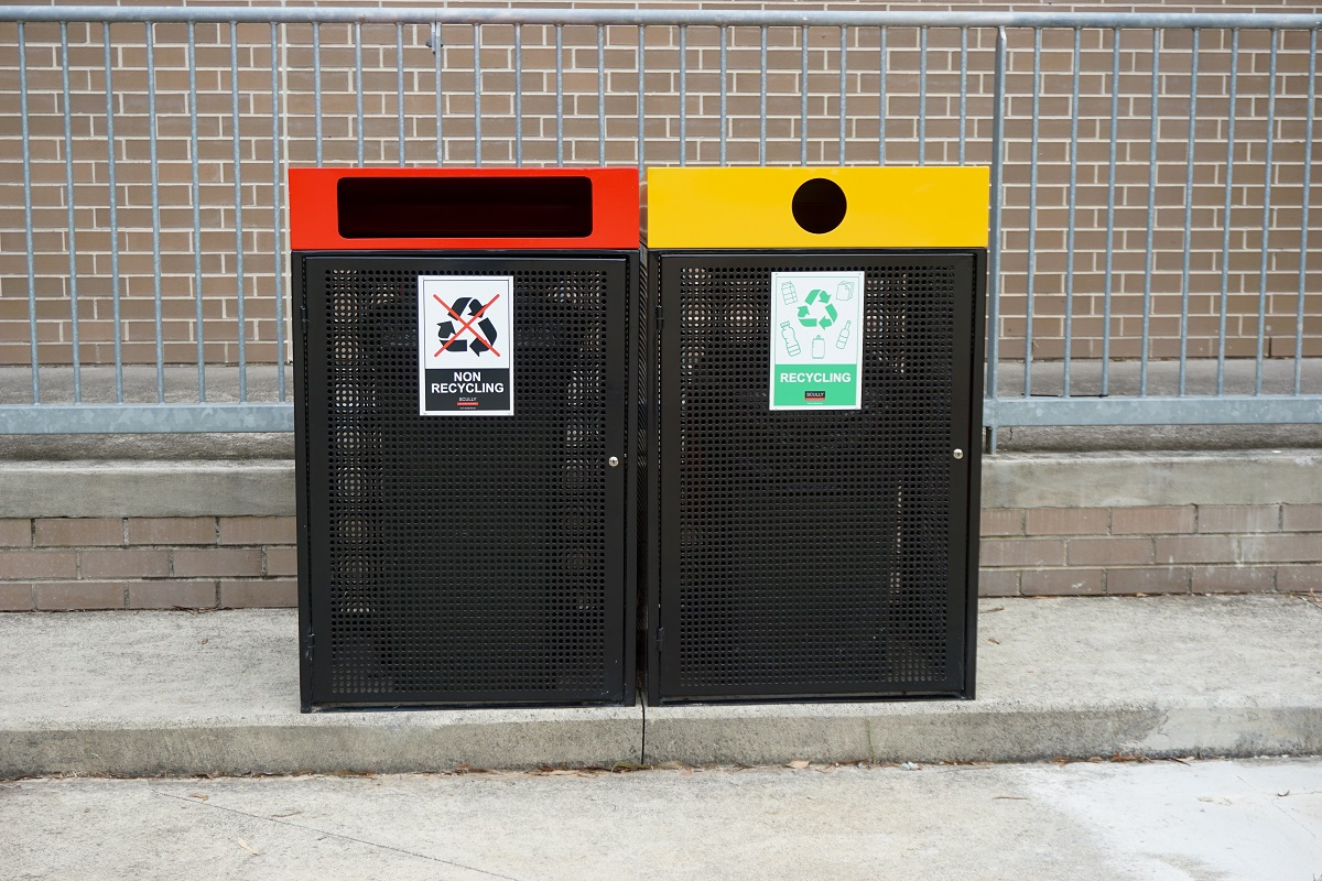 2 bins positioned side by side with one for General rubbish and another for recycling