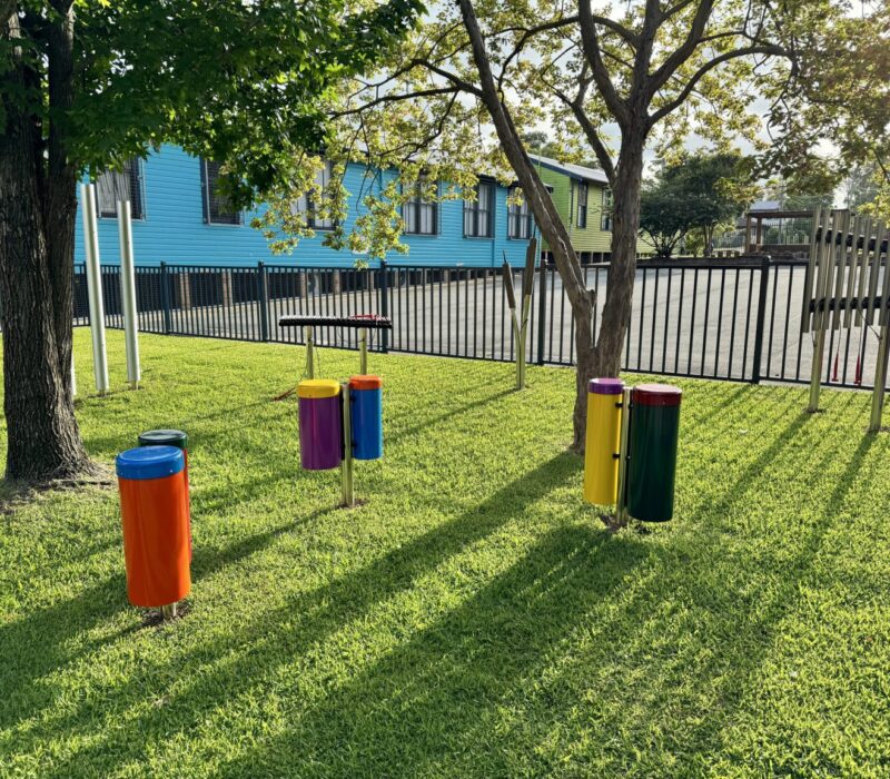 Percussion Play Outdoor Musical Instruments installed by Scully Outdoor Designs Australia in a school playground on the grass under some trees